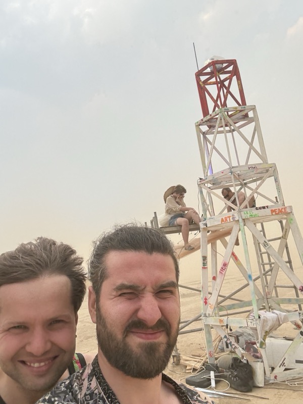 Two team members in front of the lighthouse under construction