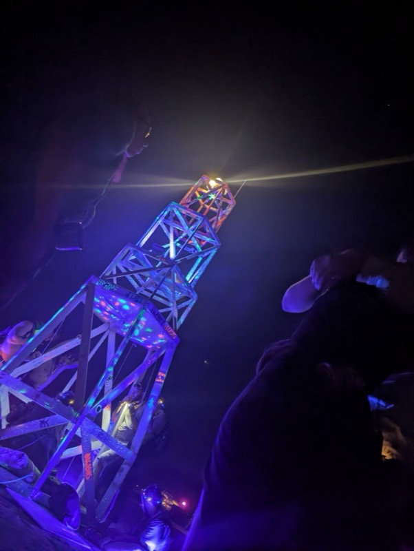 The beacon shining above the glowing frame